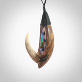 This picture shows a large matau, hook called a pā kahawai. It is carved from deer antler bone, wood, and paua shell. One only, free shipping worldwide. Provided with an adjustable black cord. Stunning work of Art to Wear by Fumio Noguchi.
